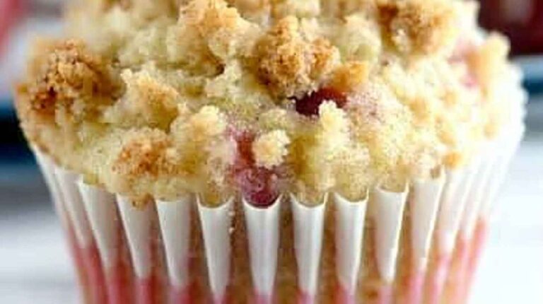 Muffin with crumb topping and visible rhubarb pieces