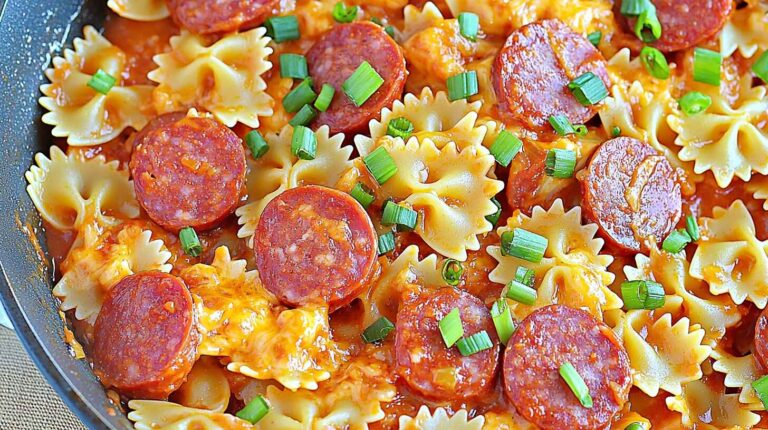 One Pot Kielbasa Pasta – Quick, Cheesy & Family-Loved Dinner 5 One pot kielbasa pasta with bowtie noodles, sausage slices, melted cheese, and green onions in a skillet