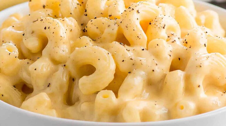 Why Crock Pot Mac and Cheese is a Game-Changer 2 Close-up of creamy crock pot macaroni and cheese in a white bowl